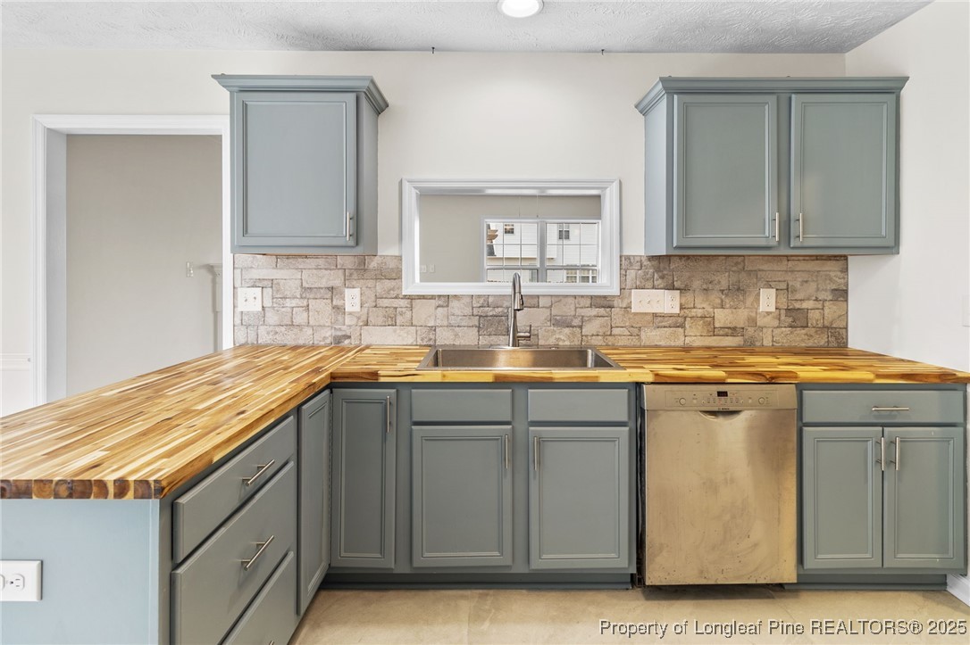 5520 Rising Ridge Drive Hope Mills, NC 28348 - Photo 7 of 30 a kitchen with a sink and cabinets