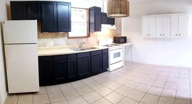 a kitchen with a cabinets and refrigerator