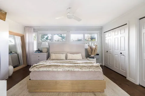 a bedroom with a large bed and a window