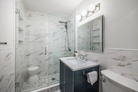 a bathroom with a sink toilet a shower and a mirror