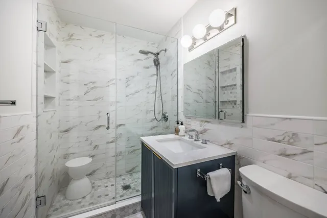 a bathroom with a sink toilet a shower and a mirror