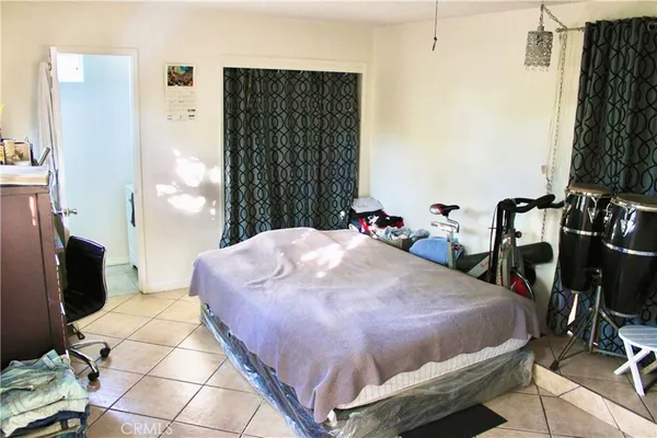 a bed sitting in a bedroom next to a window
