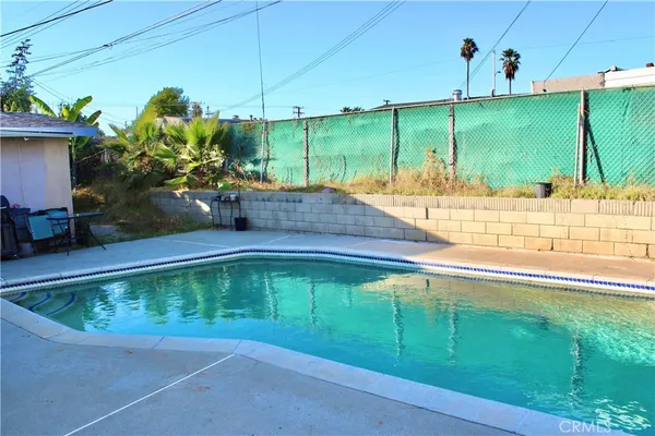 a view of a swimming pool with a yard