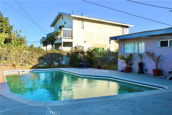 a swimming pool with outdoor seating yard and barbeque oven