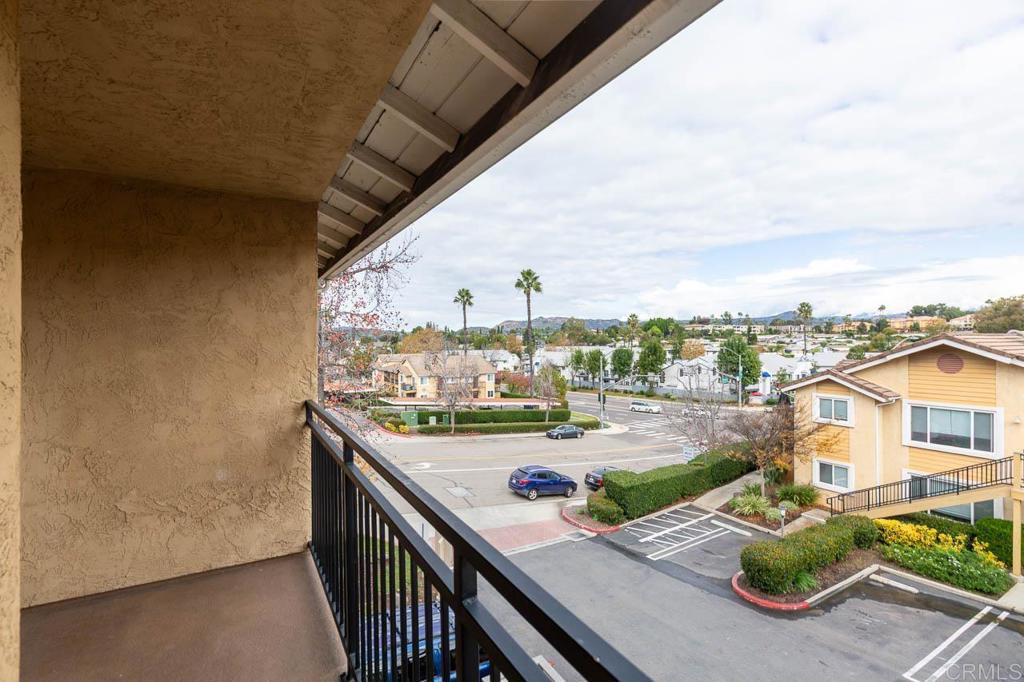 505 San Pasqual Valley Road, Unit 186 Escondido, CA 92025 - Photo 15 of 28 a view of a balcony with chair and wooden floor