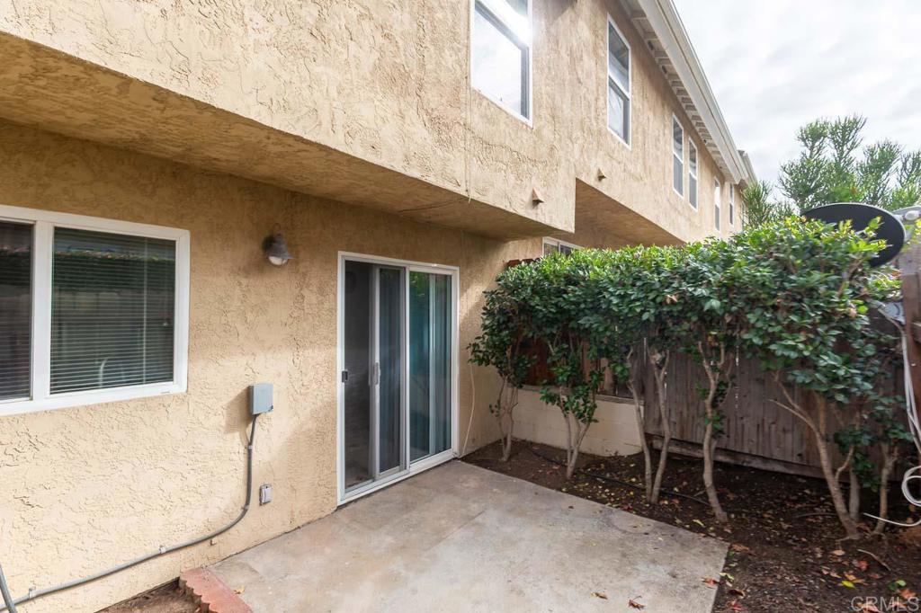 505 San Pasqual Valley Road, Unit 186 Escondido, CA 92025 - Photo 21 of 28 a backyard of a house with large trees and table and chairs