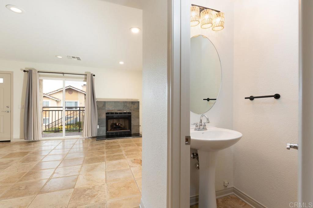 505 San Pasqual Valley Road, Unit 186 Escondido, CA 92025 - Photo 4 of 28 a bathroom with a sink a mirror and a shower