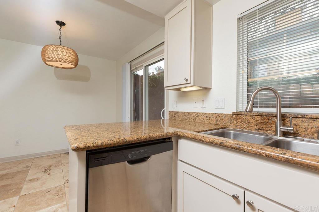 505 San Pasqual Valley Road, Unit 186 Escondido, CA 92025 - Photo 7 of 28 a kitchen with granite countertop a sink and a window