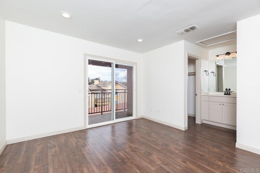 505 San Pasqual Valley Road, Unit 186 Escondido, CA 92025 - Photo 9 of 28 an empty room with wooden floor and a window