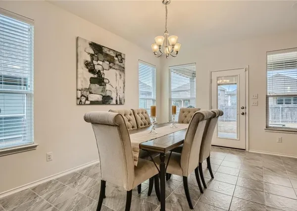 a view of a dining room with furniture and a chandelier