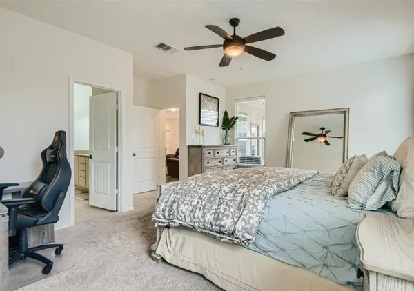 a bedroom with a bed a desk and chair