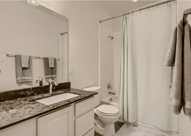 a bedroom with a bed and a wall painting