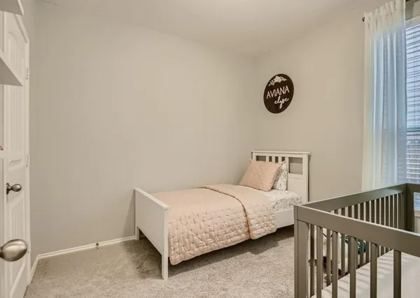 a bedroom with a bed and a wall painting