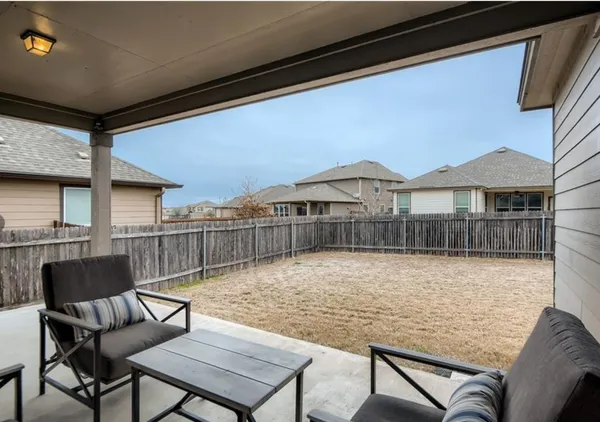a swimming pool with outdoor seating and yard