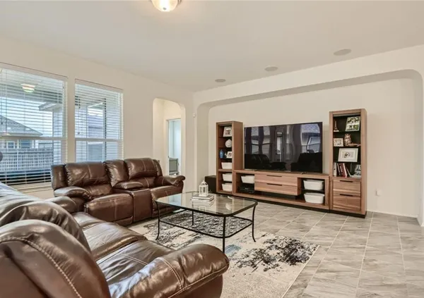 a living room with furniture window and wall painting