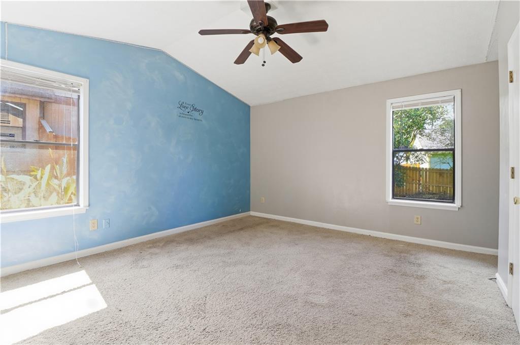 5288 Biffle Downs Road Stone Mountain, GA 30088 - Photo 11 of 18 an empty room with windows and fan