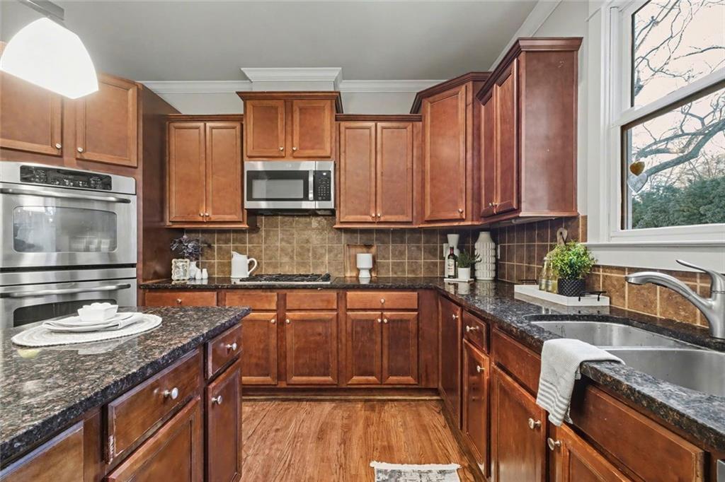 3105 Brick Lane Decatur, GA 30033 - Photo 32 of 72 a kitchen with stainless steel appliances granite countertop a sink stove and microwave