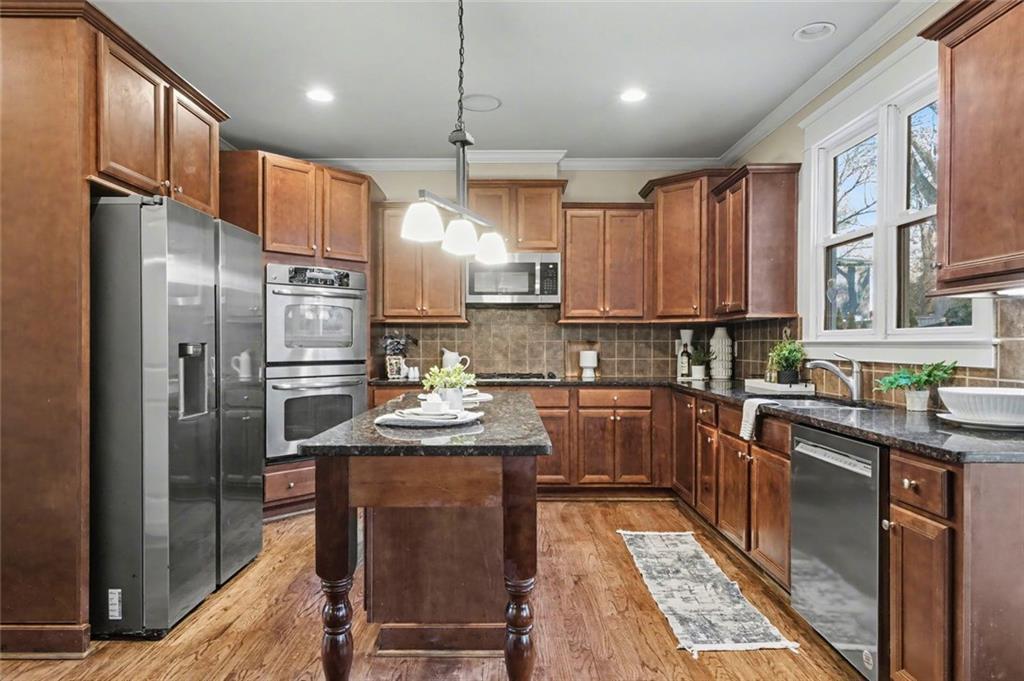 3105 Brick Lane Decatur, GA 30033 - Photo 35 of 72 a kitchen with stainless steel appliances granite countertop a sink refrigerator and cabinets