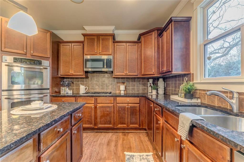 3105 Brick Lane Decatur, GA 30033 - Photo 38 of 72 a kitchen with stainless steel appliances granite countertop a sink stove and cabinets