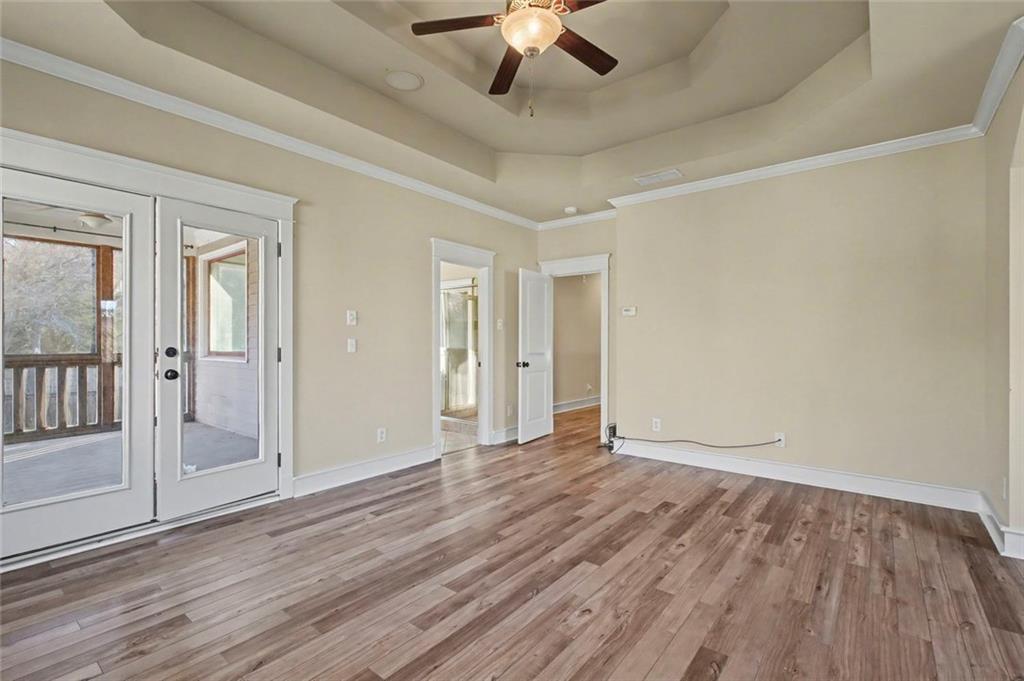 3105 Brick Lane Decatur, GA 30033 - Photo 44 of 72 a view of an empty room with wooden floor and a ceiling fan