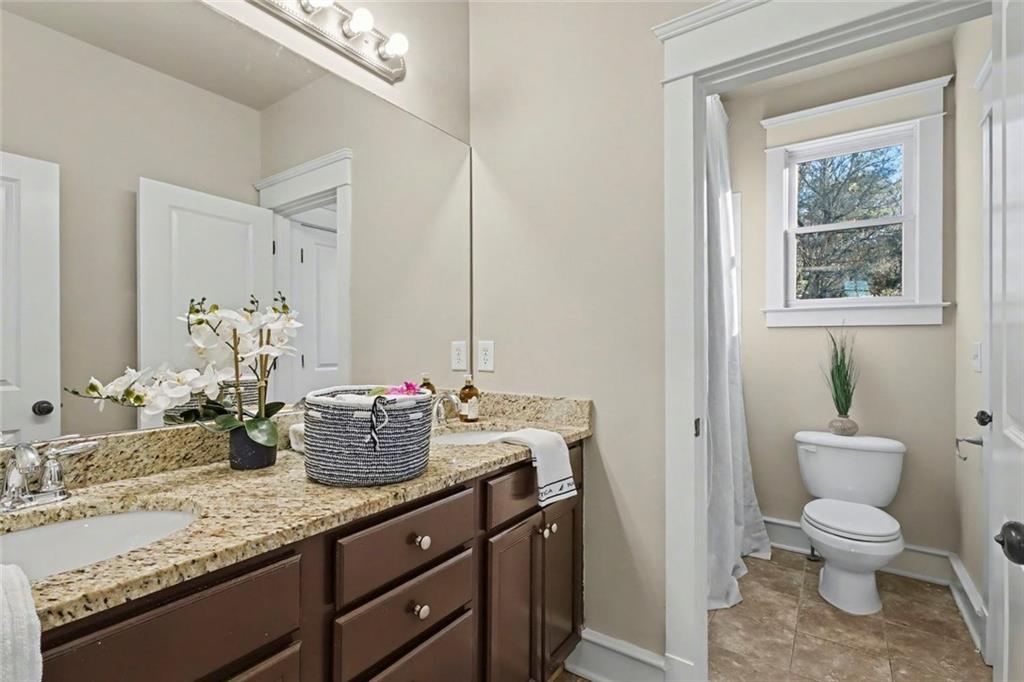 3105 Brick Lane Decatur, GA 30033 - Photo 59 of 72 a bathroom with a granite countertop sink mirror vanity and toilet