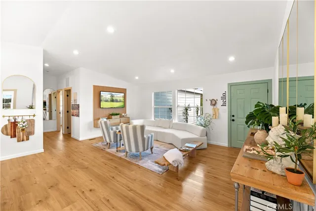 a living room with furniture fireplace and wooden floor