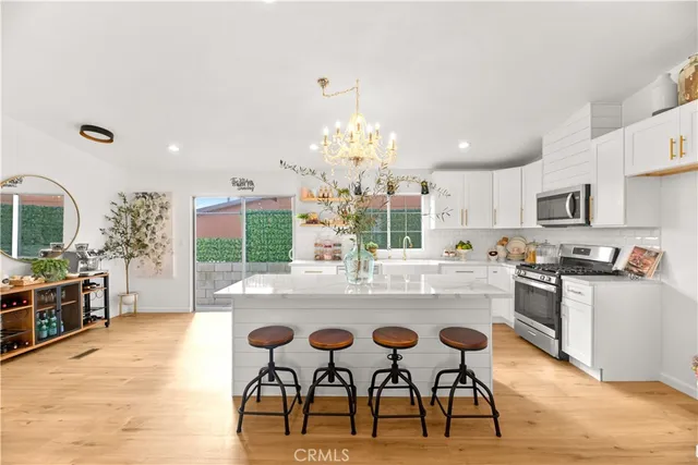 a large kitchen with a table and chairs