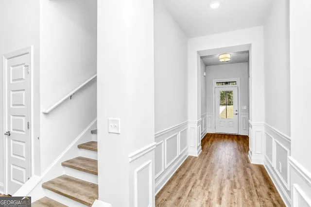 a large kitchen with a refrigerator and white cabinets