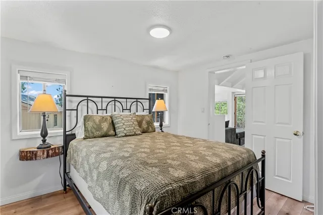 a spacious bedroom with a bed and a painting on the wall