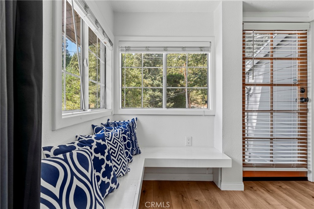 1139 Bear Springs Road Twin Peaks, CA 92391 - Photo 23 of 45 a view of a bedroom with wooden floor and furniture