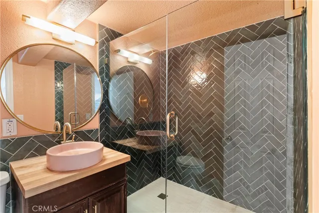 a bathroom with a sink mirror vanity and toilet