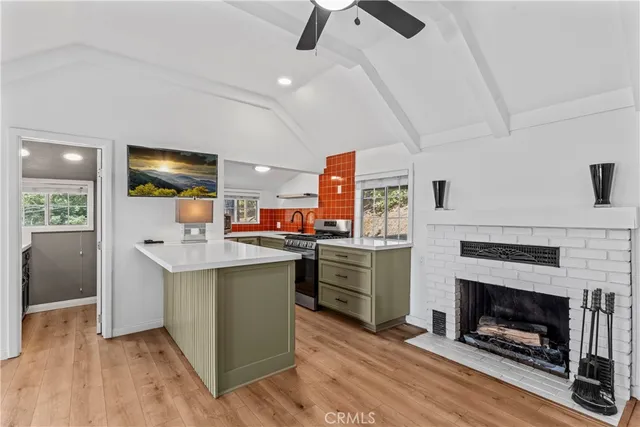 a kitchen with stainless steel appliances granite countertop a stove cabinets and wooden floor