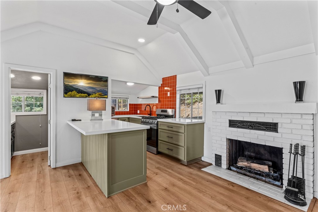 1139 Bear Springs Road Twin Peaks, CA 92391 - Photo 5 of 45 a kitchen with stainless steel appliances granite countertop a stove cabinets and wooden floor