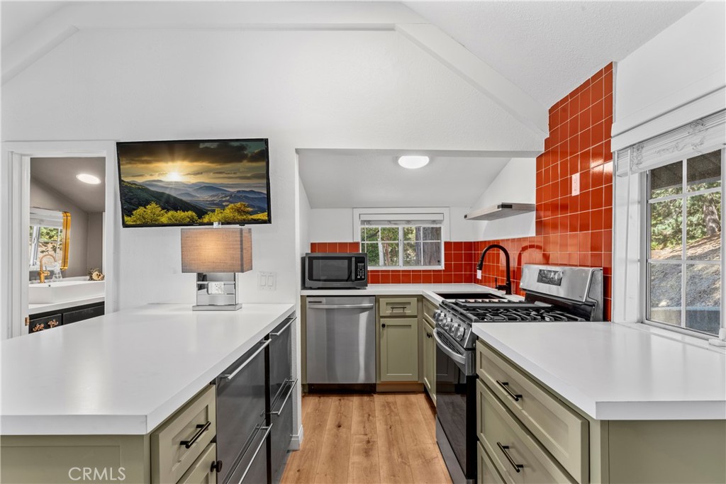 1139 Bear Springs Road Twin Peaks, CA 92391 - Photo 6 of 45 a kitchen with stainless steel appliances a stove a sink and a refrigerator