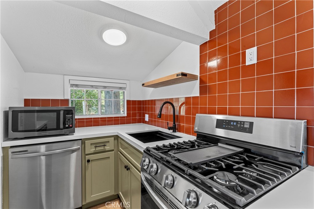 1139 Bear Springs Road Twin Peaks, CA 92391 - Photo 8 of 45 a stove top oven sitting inside of a kitchen