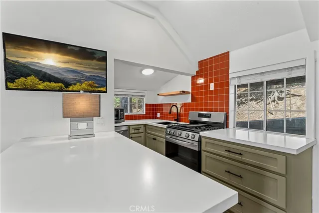 a kitchen with stainless steel appliances granite countertop a stove and a refrigerator