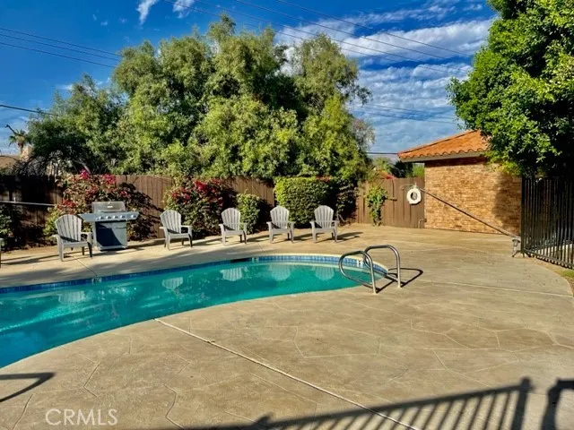 a view of backyard with swimming pool