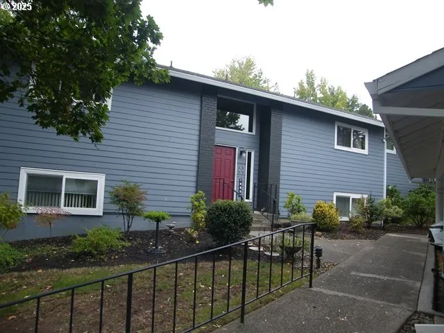 a view of a house with wooden fence