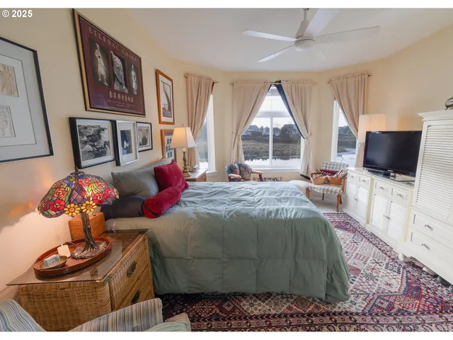 a bedroom with a bed and flat screen tv