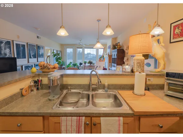 a kitchen with a sink a counter top space and appliances