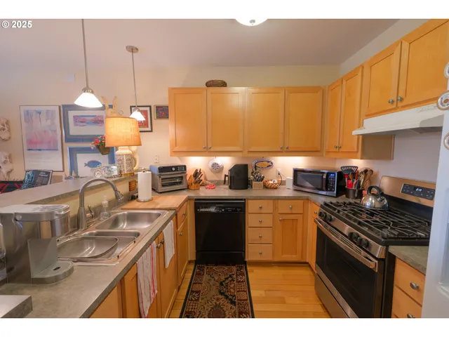 a kitchen with a sink stove and cabinets