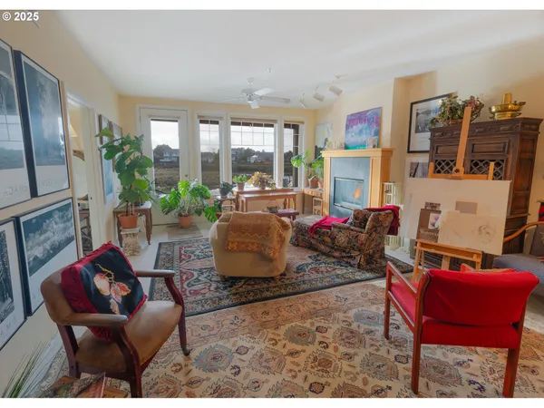 a living room with furniture and a floor to ceiling window
