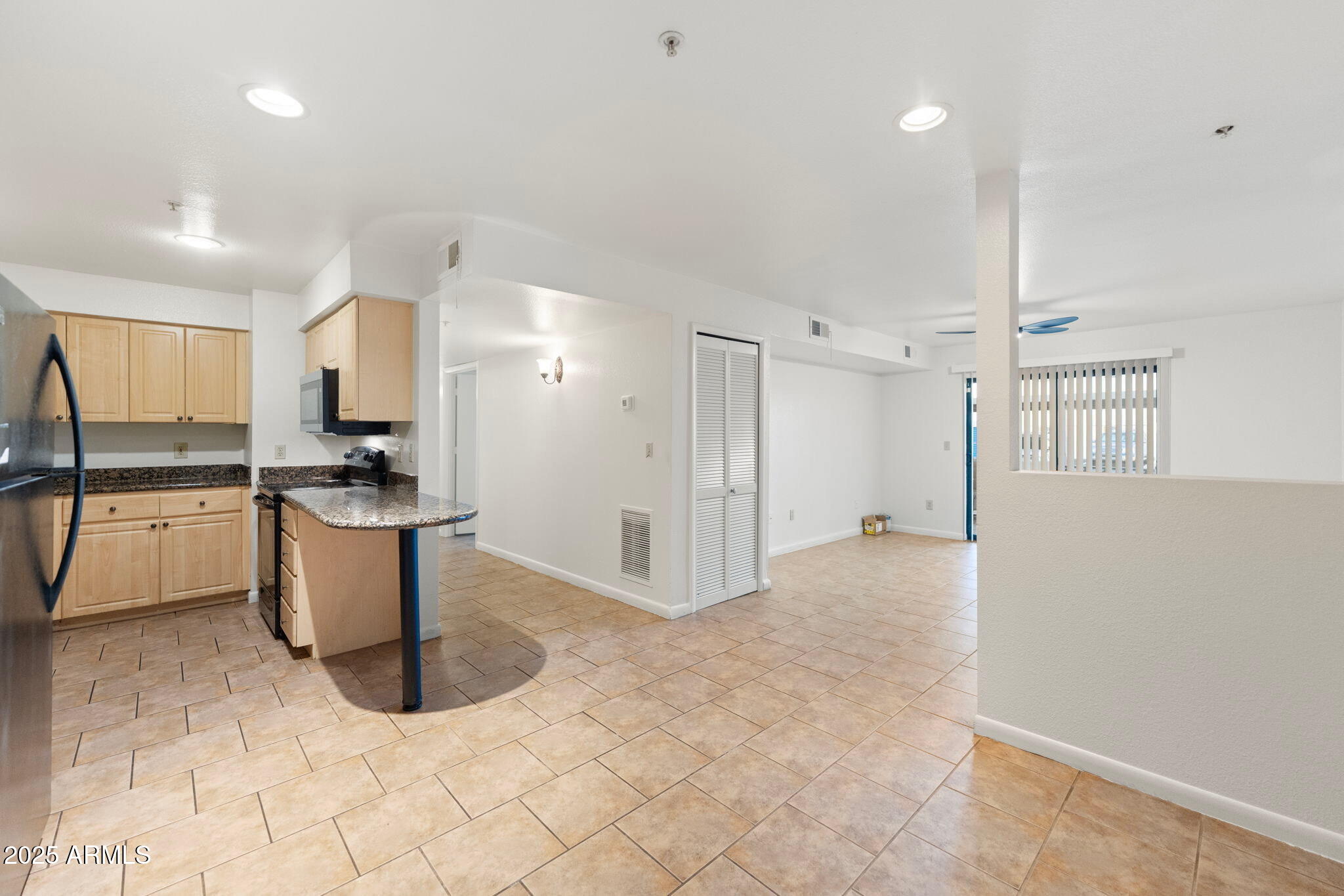 1005 East 8th Street, Unit 1012 Tempe, AZ 85281 - Photo 1 of 16 a kitchen with stainless steel appliances kitchen island granite countertop a refrigerator and a stove top oven