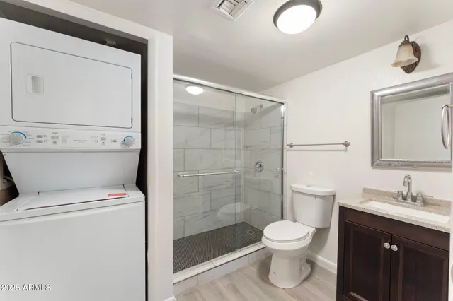 a bathroom with a toilet a sink and a mirror