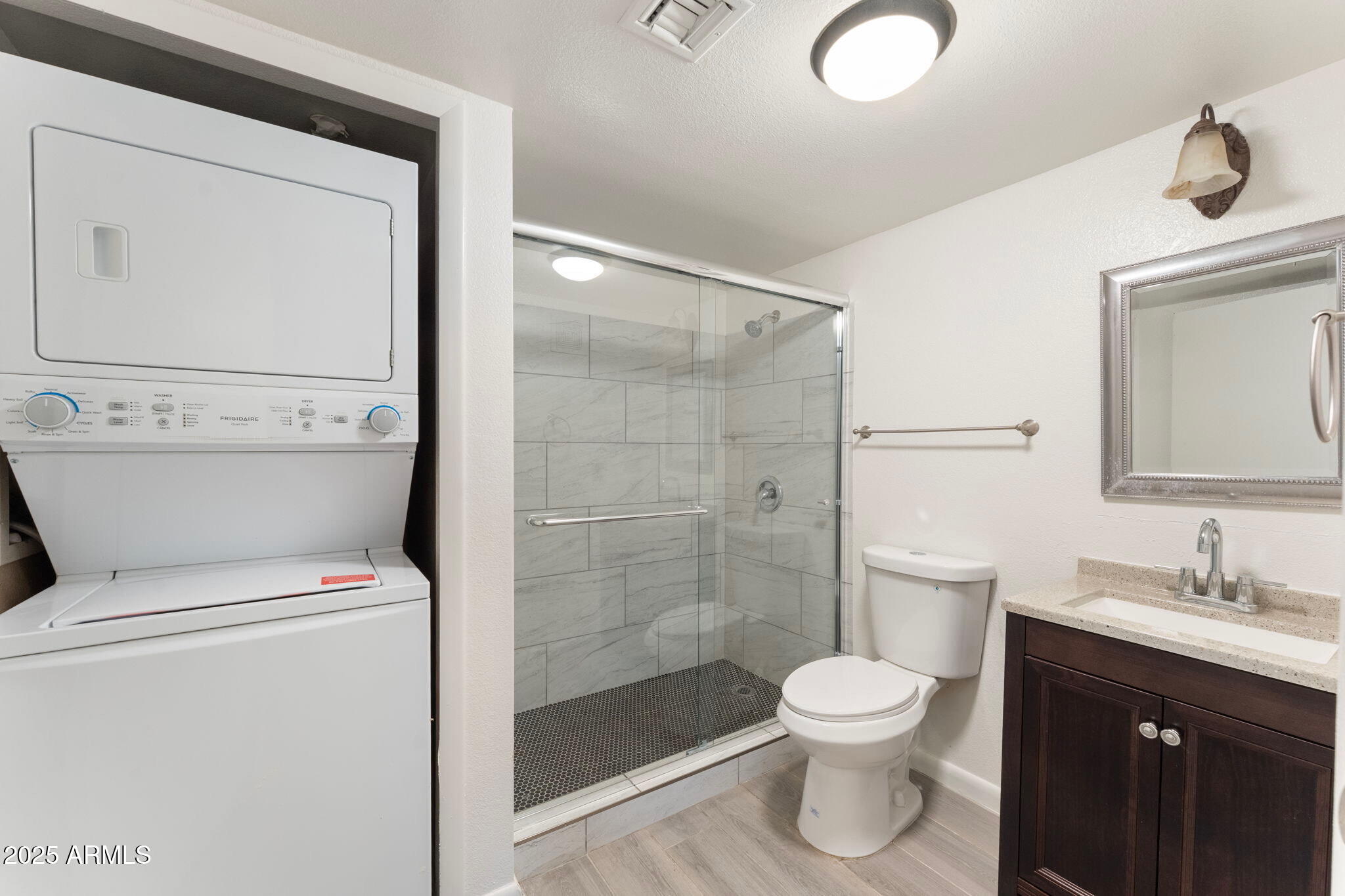 1005 East 8th Street, Unit 1012 Tempe, AZ 85281 - Photo 12 of 16 a bathroom with a toilet a sink and a mirror