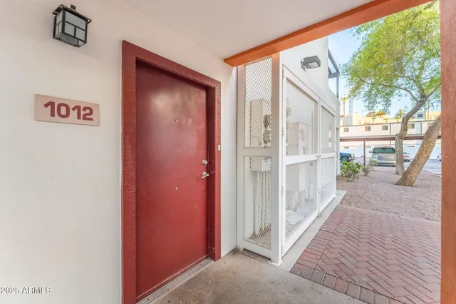 a view of a porch with wooden floor and doors