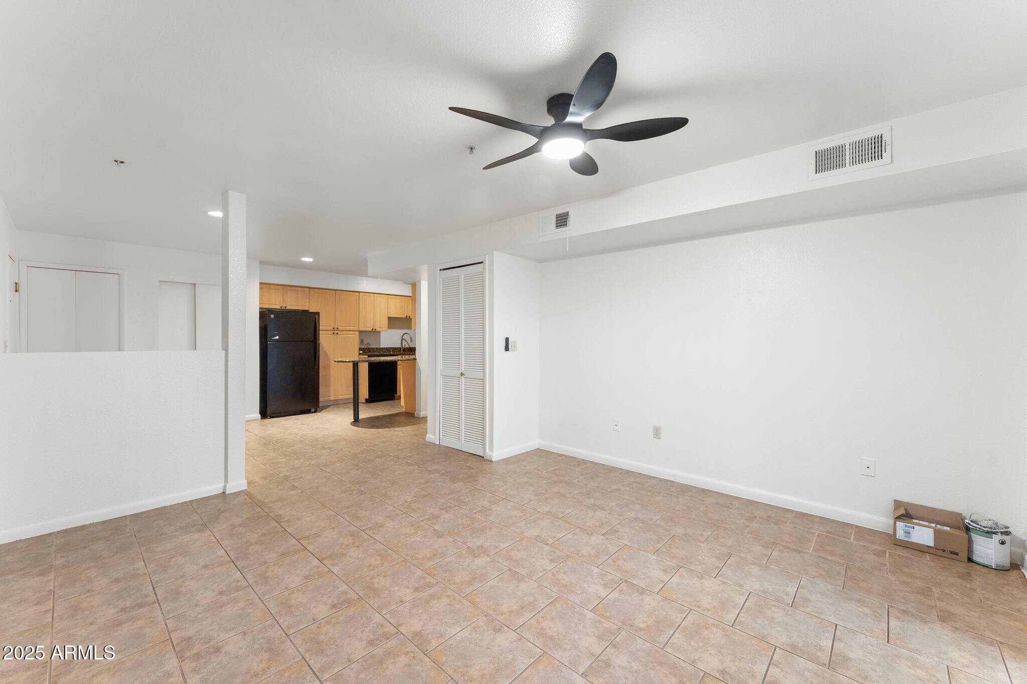 1005 East 8th Street, Unit 1012 Tempe, AZ 85281 - Photo 3 of 16 an empty room with a ceiling fan and a window