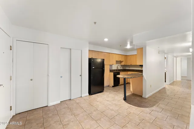 a kitchen with a refrigerator and a sink