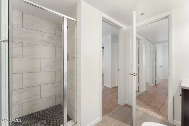 a bathroom with a shower and a glass door