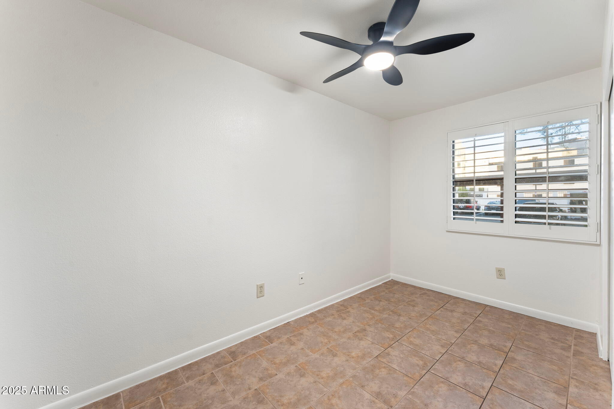 1005 East 8th Street, Unit 1012 Tempe, AZ 85281 - Photo 10 of 16 an empty room with a window and a fan